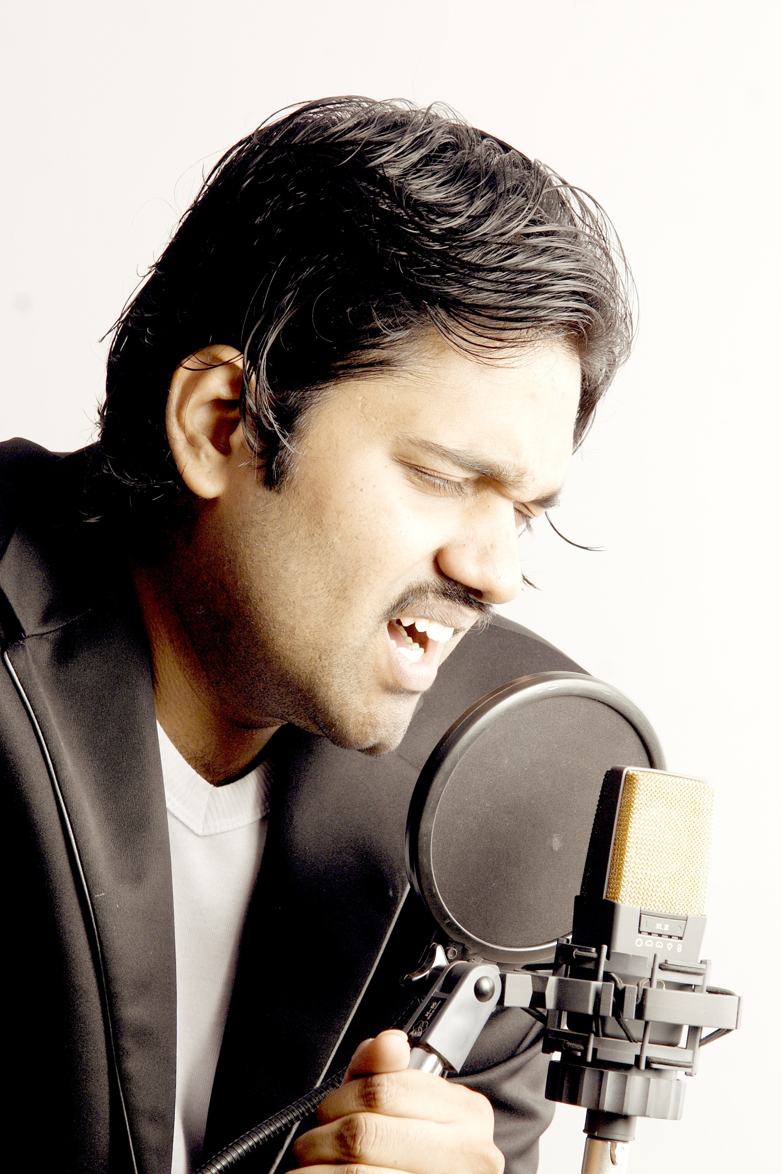 PC Shivan recording at a studio microphone